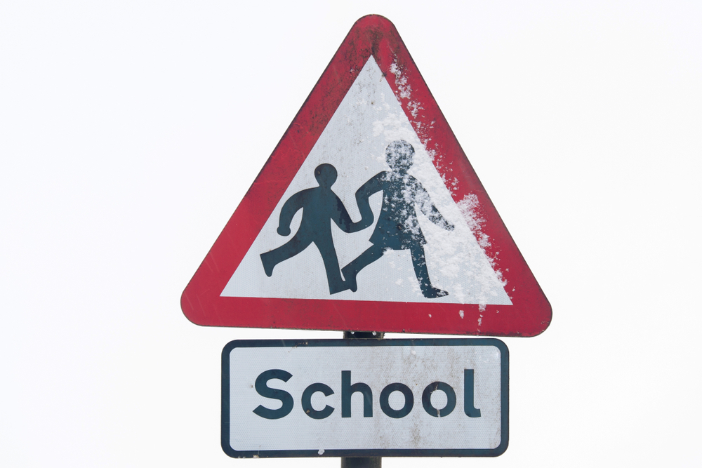 School sign with snow