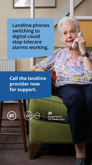 An older woman sitting on the couch and speaking on a landline phone.