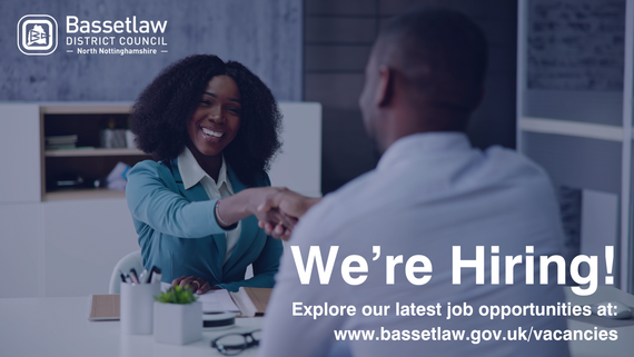 Two people shaking hands in a job interview.