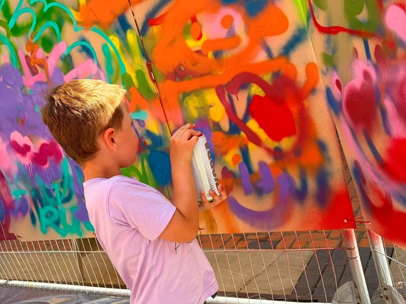 Child spray-painting.