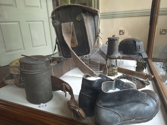 Photograph of mining boots, lamp and other artefacts