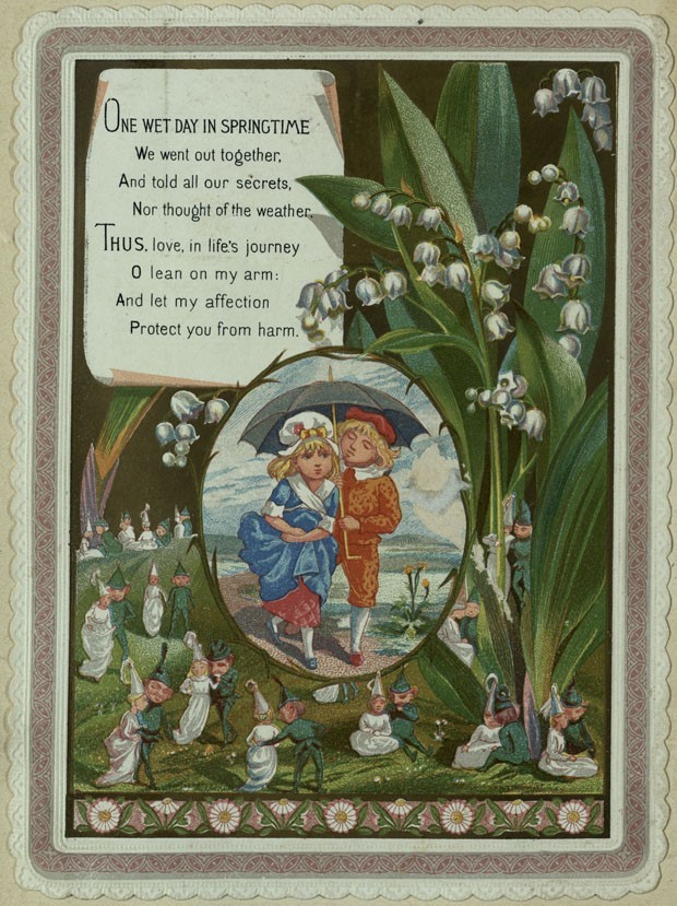 Colourful greetings card showing an image of a boy & girl under an umbrella walking, set into a scene of white flowers & tiny elf couples.