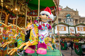 Perry rides the carousel at the Birmingham Frankfurt Christmas Market
