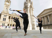 Three dancers celebrate the launch of the Birmingham 2022 Festival in Chamberlain Square, Birmingham. 