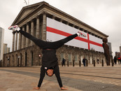 Team England gymnast Joe Fraser does a handstand in front of Birmingham Town Hall. 