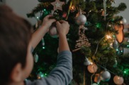 Boy decorating a Christmas tree