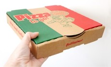 Hand holding a take away pizza box