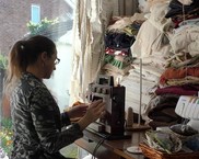 Woman sat at sewing machine