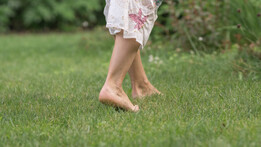 Barefoot walking on grass