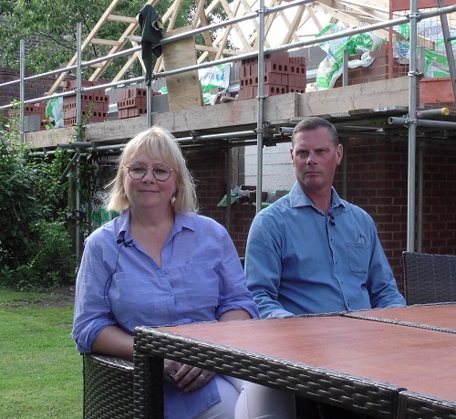 Louise and Andrew Sutton sat in their garden