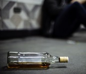Alcohol bottle on the floor