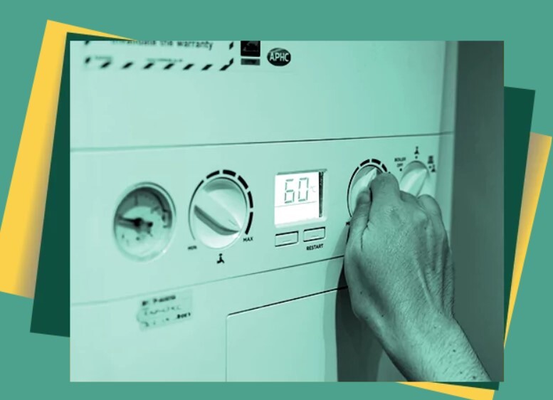 Person turning a dial on a boiler