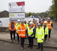 Councillors and contractors standing on building site