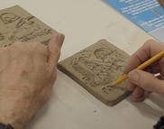 Close up of person creating a tile