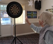 Lady playing darts 