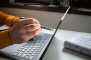 Hands working on a laptop