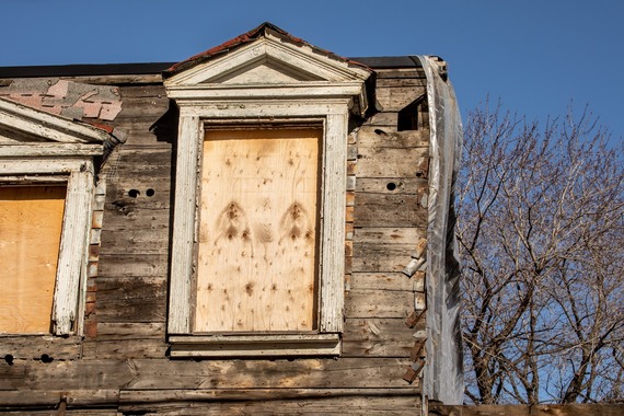 Boarded up window on old house