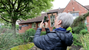 Cllr raspin taking a photo of a tree