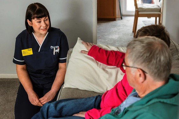 Ashgate Hospice nurse sitting with two people
