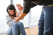Woman cowering from a man