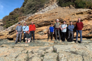 BGS and the CNR-IGG team at the Zuccale Fault outcrop, posing in front of a ripped-up ophiolite fragment in the faulted sediments.