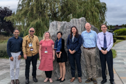 Visitors from the Indonesian Embassy and BGS staff standing in front of a stone outside of the BGS headquarters.
