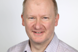 A headshot of Gavin Mudd, who is wearing a shirt.