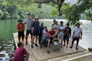 A group of people smile into the camera. They are on a raft on Lake Bulusan.