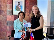 BGS and Chile stand with the Chilean critical minerals strategy brochure at the MoU signing.