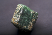 Apatite, a phosphorus-bearing mineral. The mineral is green and shaped into a cube. 