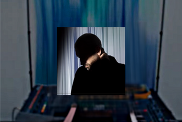 A screengrab from Tepr's song Mirrors featuring his silhouette with the silhouette of audio equipment and a blue cloth in the background