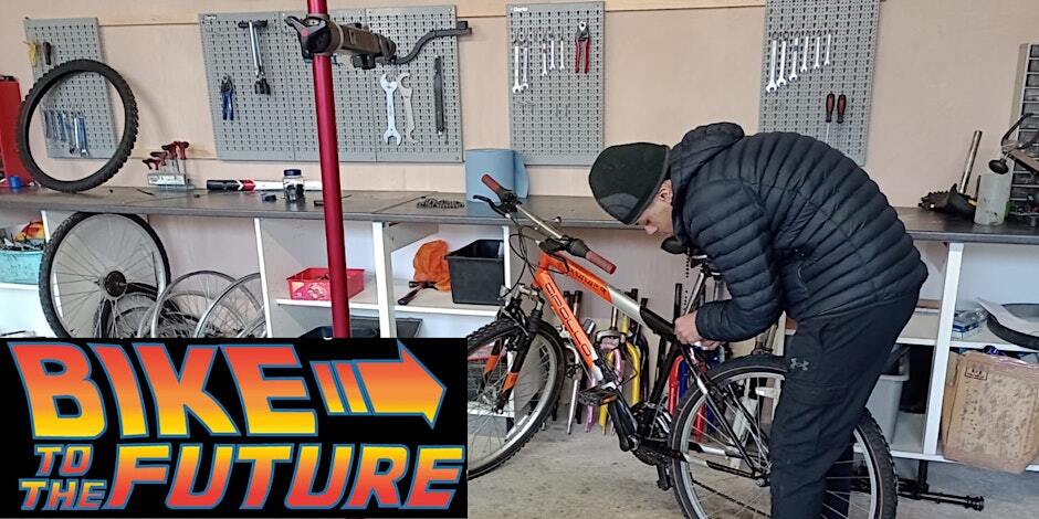 Photo of someone mending a bike in a workshop