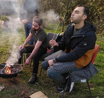 Photo of two men enjoying a barbecue