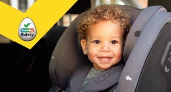 Photo of child in a car seat smiling at the camera