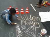 Photo of a child chalk drawing on a street