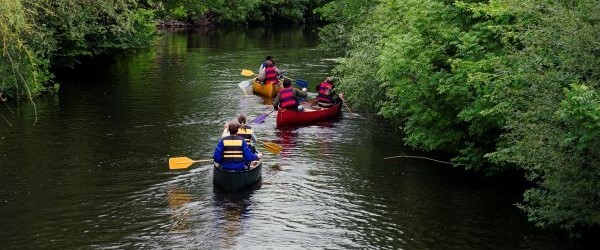 People canoeing away from the camera