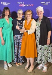 Women from Silsden Repair Cafe with trophy
