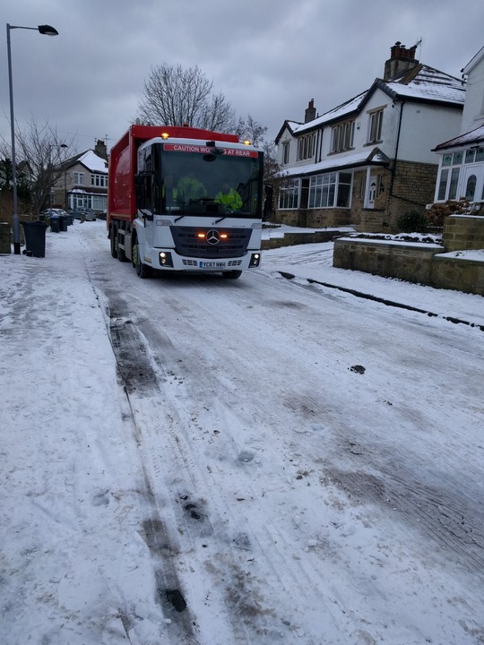 Bin wagon emptying bins in snow