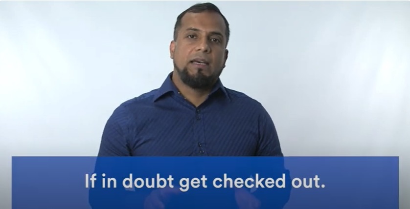 Screenshot taken from one of the films showing a man talking onscreen with the words: if in doubt get checked out