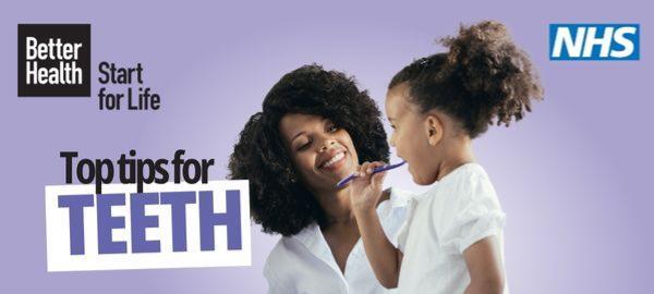 Photograph of a women smiling as a child brushes her teeth