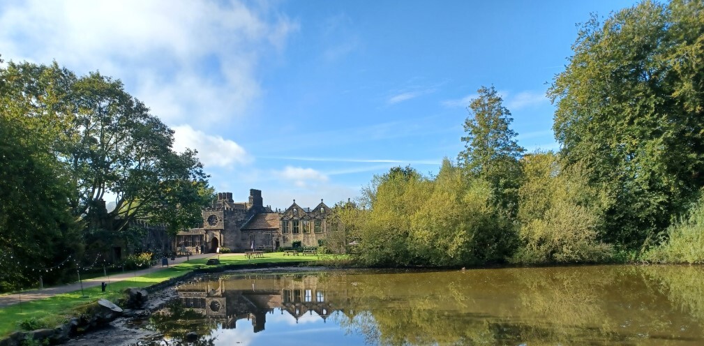 An old building in front of a lake