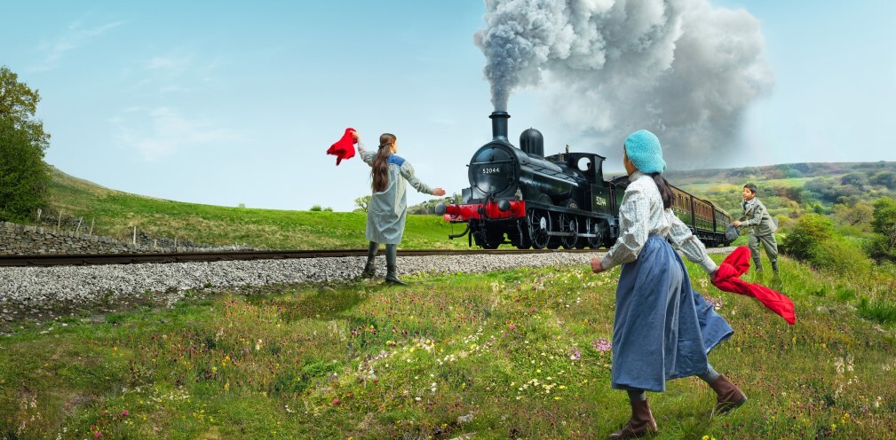 A group of children watching a train