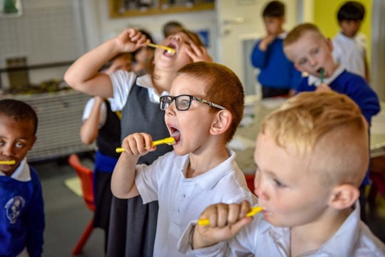 Photo of school children brushing their teeth