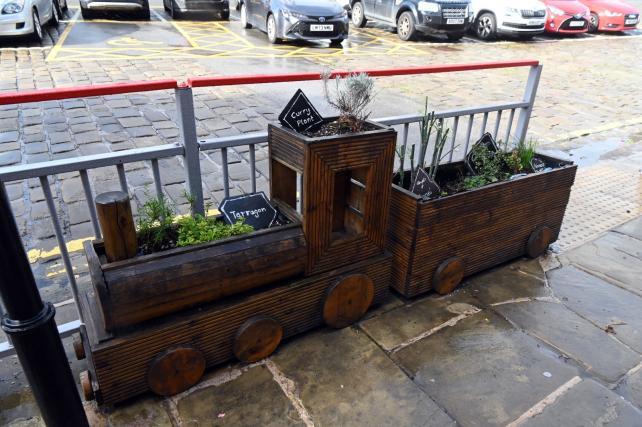 Train shaped wooden planter with herbs and other edibles