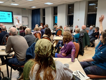 Backs of people's heads looking at a powerpoint - only using on request