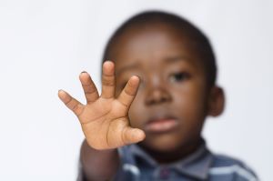 Young black boy with outstretched hand