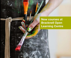Person holding paint brushes to promote new learning courses