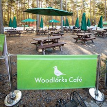 Woodlarks cafe sign and outdoor dining area