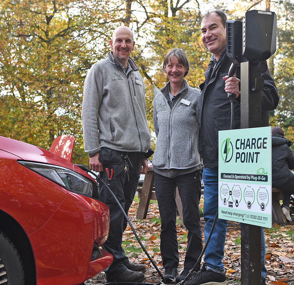 John, Kath and Cllr Harrison charging a car using the new EV charge point.