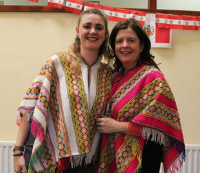 Lindsay Carter and Nicolette Gilmour dressed in ponchos at the armchair holiday to peru